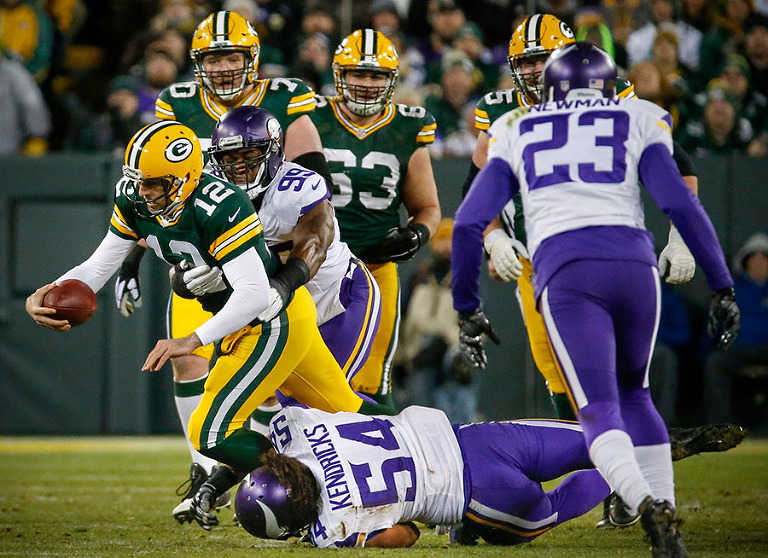 Minnesota Vikings defensive end Danielle Hunter and middle linebacker Eric Kendricks take down Green Bay Packers quarterback Aaron Rodgers.