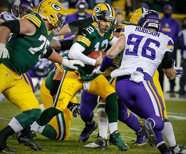 Green Bay Packers quarterback Aaron Rodgers tries to escape the Viking defense.