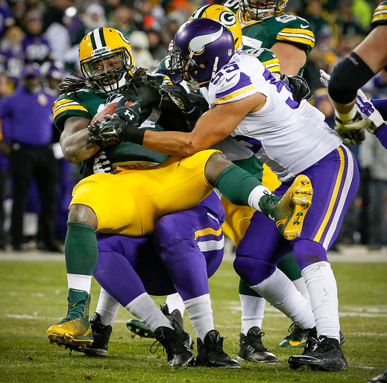 The Viking defense stops Green Bay Packers running back Eddie Lacy behind the line of scrimmage.