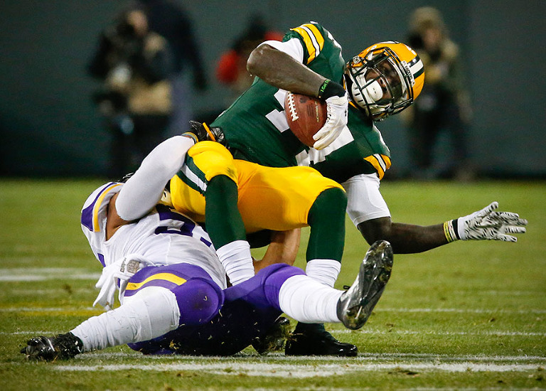 Minnesota Vikings outside linebacker Anthony Barr stops Green Bay Packers running back James Starks.