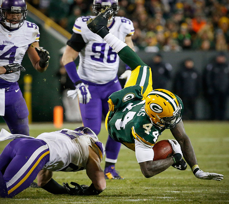 Green Bay Packers running back James Starks gets tripped up by the Vikings defense.