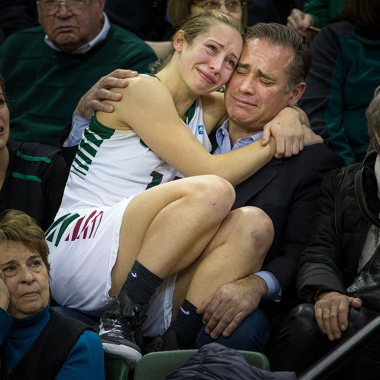 Green Bay women's basketball's Megan Lukan goes in to the stands to hug her dad John during senior day for the Phoenix