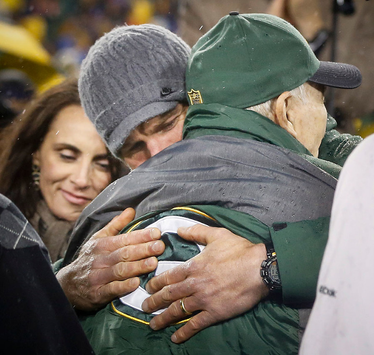 Former Green Bay Packers quarterbacks Brett Favre and Bart Starr hug during a halftime ceremony retiring Favre's number from the Packers