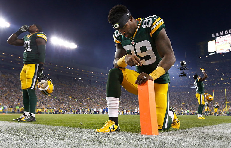 Green Bay Packers wide receiver James Jones prays before their game against the Vikings.