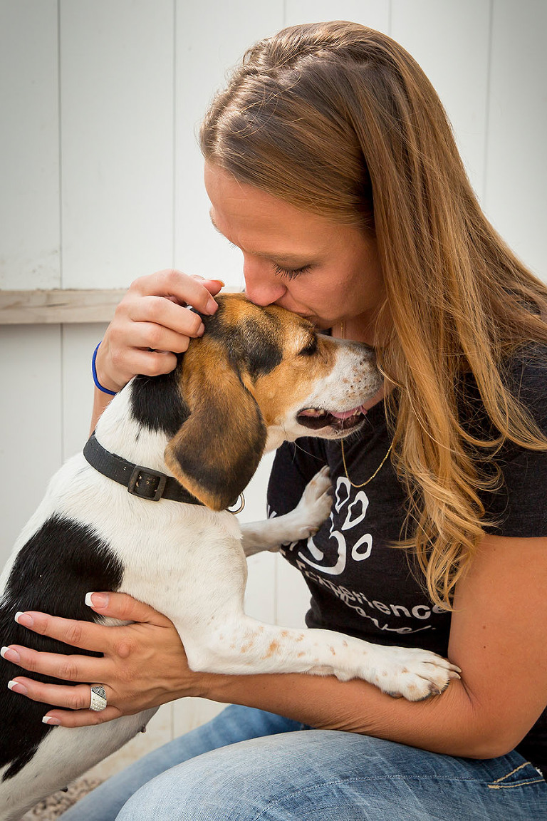 Amanda Reitz, founder of Happily Ever After, a no kill animal shelter shows her love to one of the dogs at the facility.