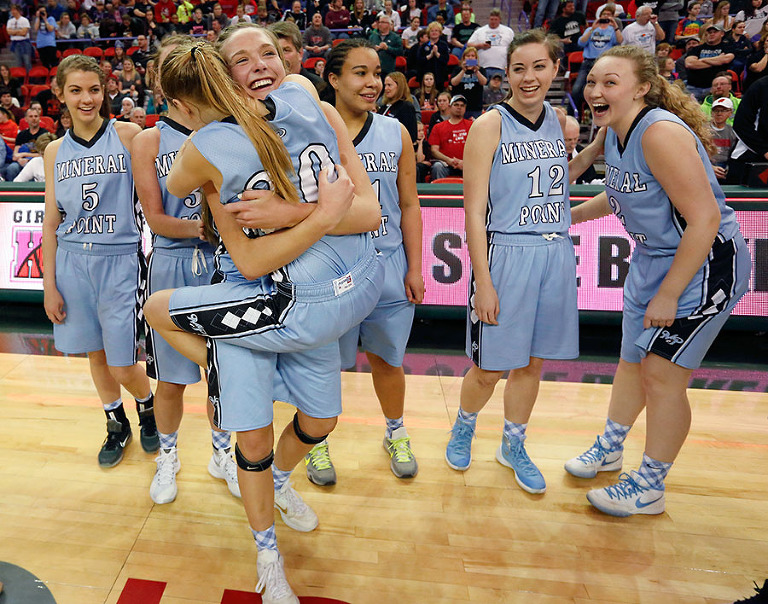 Mineral Point's Sydney Staver lifts up a hugs Clara Chamber after defeating Kenosha St. Joseph's 68-52 in the Division 4 finals.