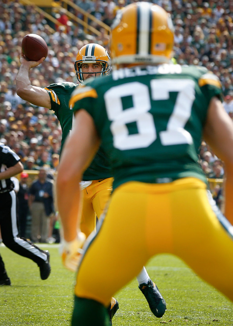 Green Bay Packers quarterback Aaron Rodgers throws a touchdown pass to Jordy Nelson.