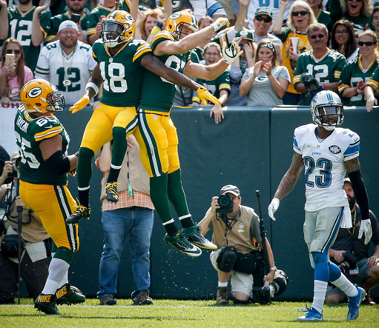 Green Bay Packers wide receiver Randall Cobb helps Jordy Nelson celebrate his touchdown.