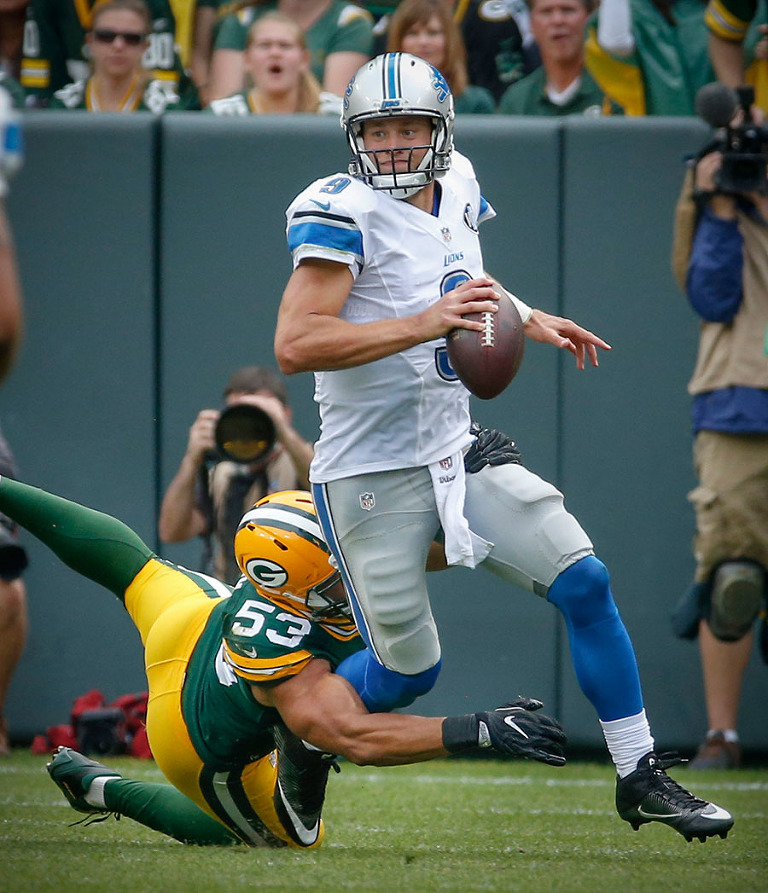 Detroit Lions quarterback Matthew Stafford tries to get away from Green Bay Packers outside linebacker Nick Perry.