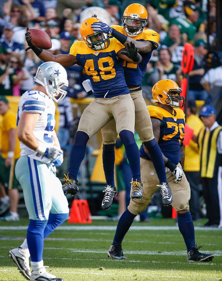 Green Bay Packers linebacker Joe Thomas celebrates an interception.