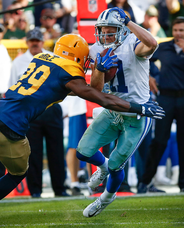 Green Bay Packers defensive back Kentrell Brice tries to stop Dallas Cowboys wide receiver Cole Beasley.