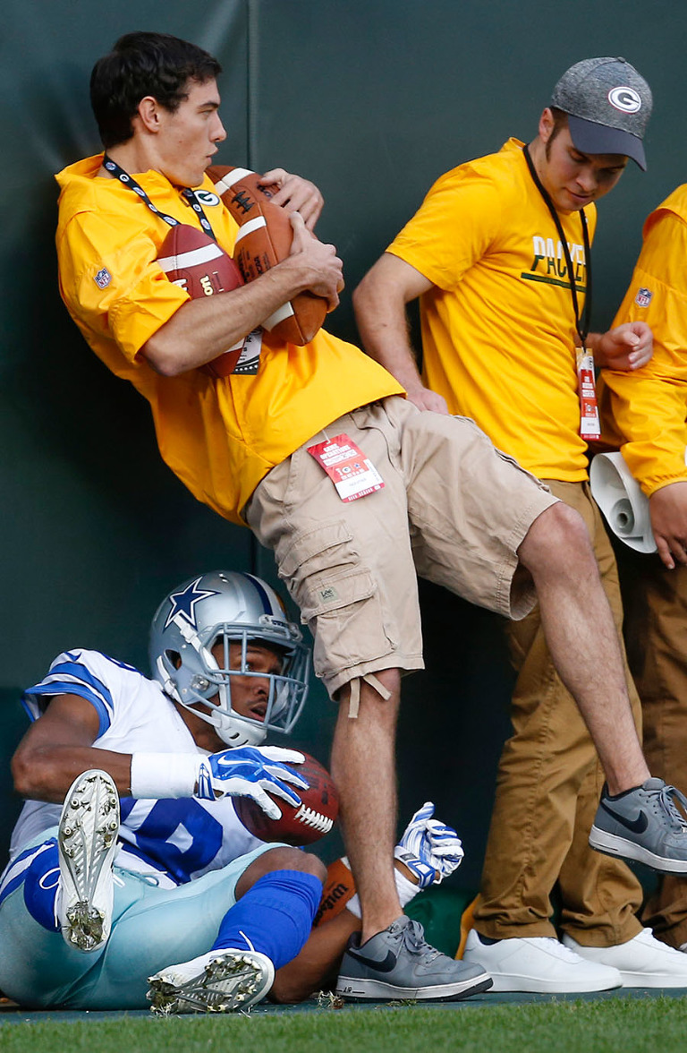 Cowboys Brice Butler tires to hide behind a ball boy after scoring a touchdown.