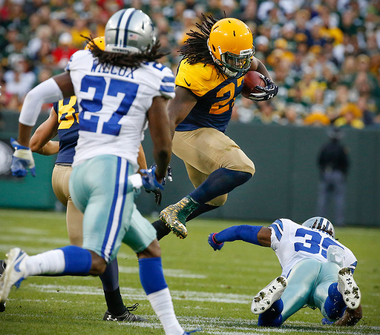 Green Bay Packers running back Eddie Lacy leaps over Dallas Cowboys cornerback Brandon Carr.