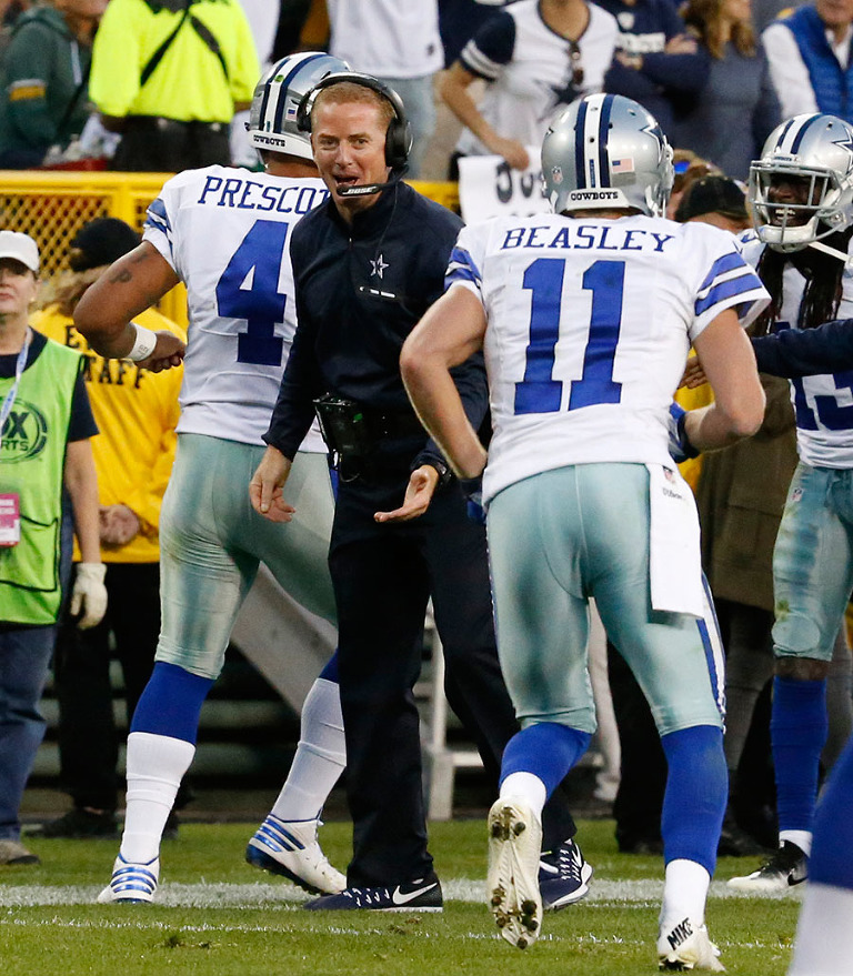 Dallas Cowboys head coach Jason Garrett celebrates a touchdown with quarterback Dak Prescott and wide receiver Cole Beasley.