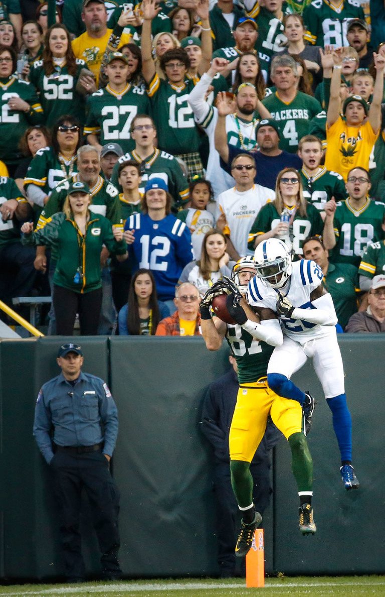 Green Bay Packers wide receiver Jordy Nelson catches a touchdown pass around the defensive pressure of Indianapolis Colts cornerback Darius Butler.