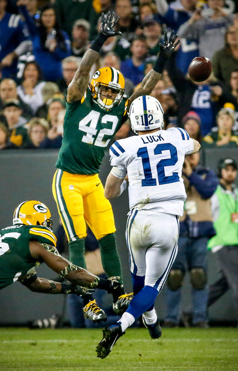 Green Bay Packers strong safety Morgan Burnett tries to block a Indianapolis Colts quarterback Andrew Luck pass.