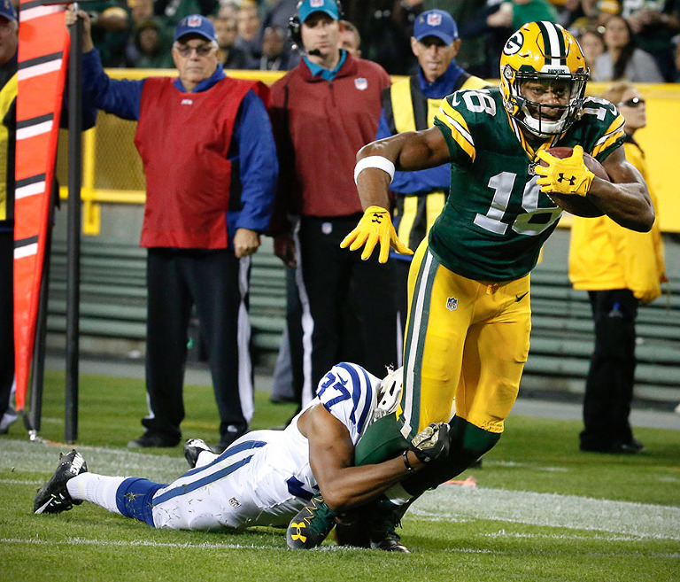 Indianapolis Colts cornerback Frankie Williams stops Green Bay Packers wide receiver Randall Cobb after a long gain.