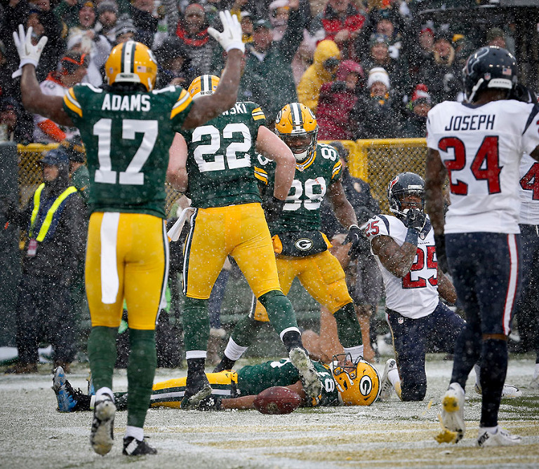 Green Bay Packers wide receiver Randall Cobb does a snow angel to celebrate a touchdown.
