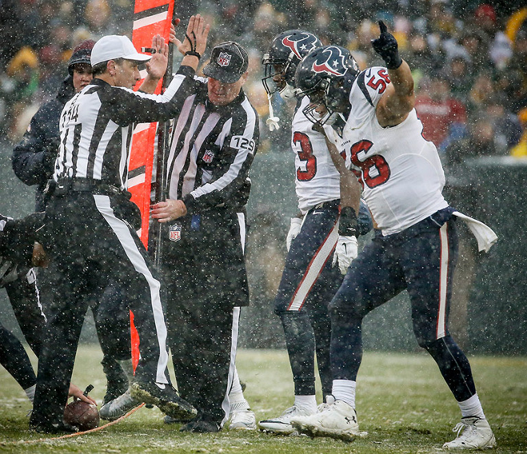 Houston Texans defense celebrate stopping the Green Bay Packers on a 4th down conversion.