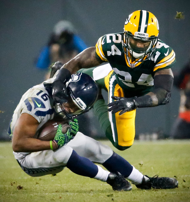 Green Bay Packers cornerback Quinten Rollins tackles Seattle Seahawks wide receiver Tyler Lockett.